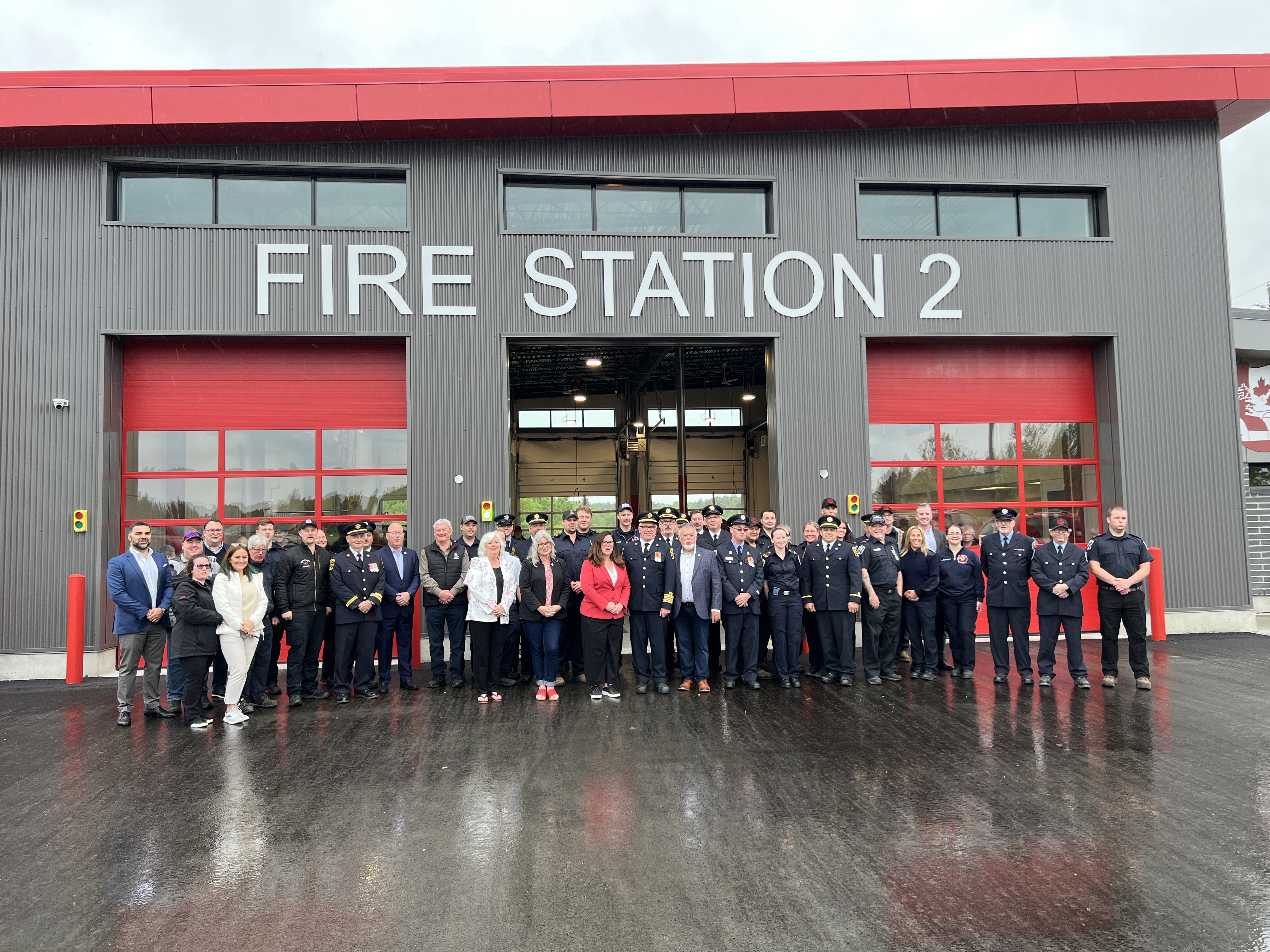 Picture of people at a grand opening event in front of the new Fire Station 2