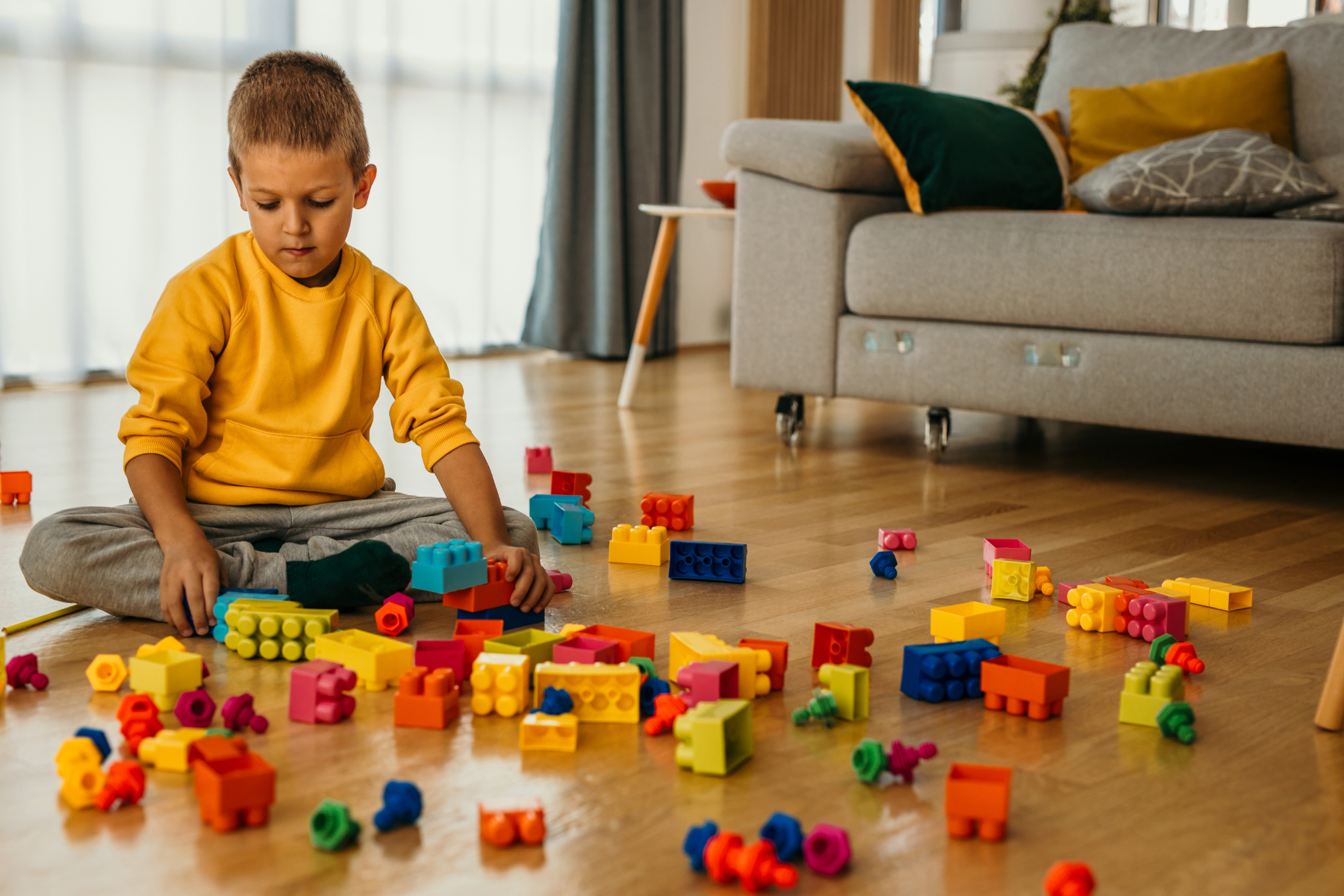 a child playing on the floor with bricks