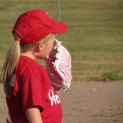 Young girl with baseball mitt