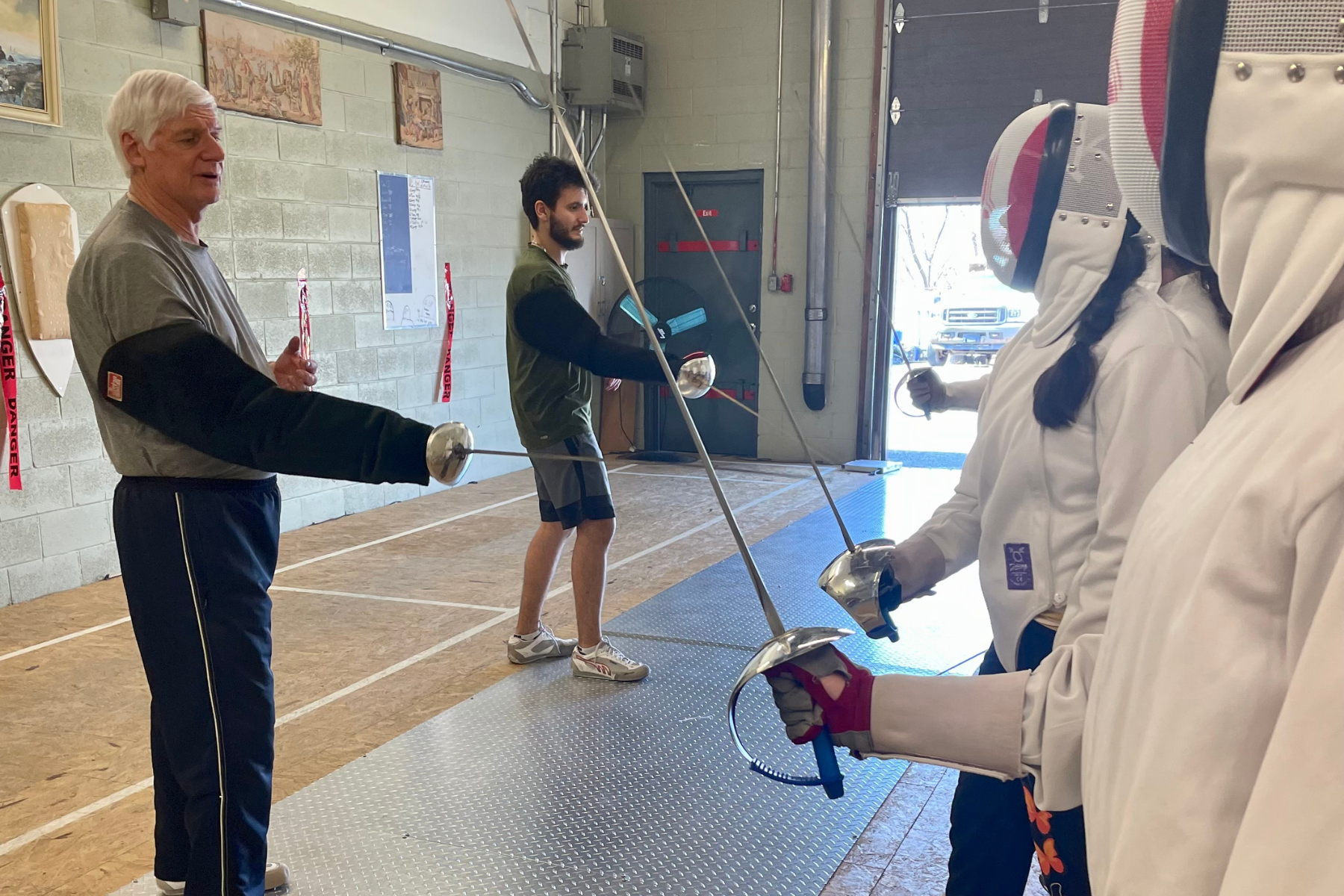Students learning how to fence