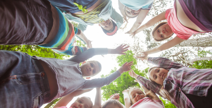 children holding their hands over their head