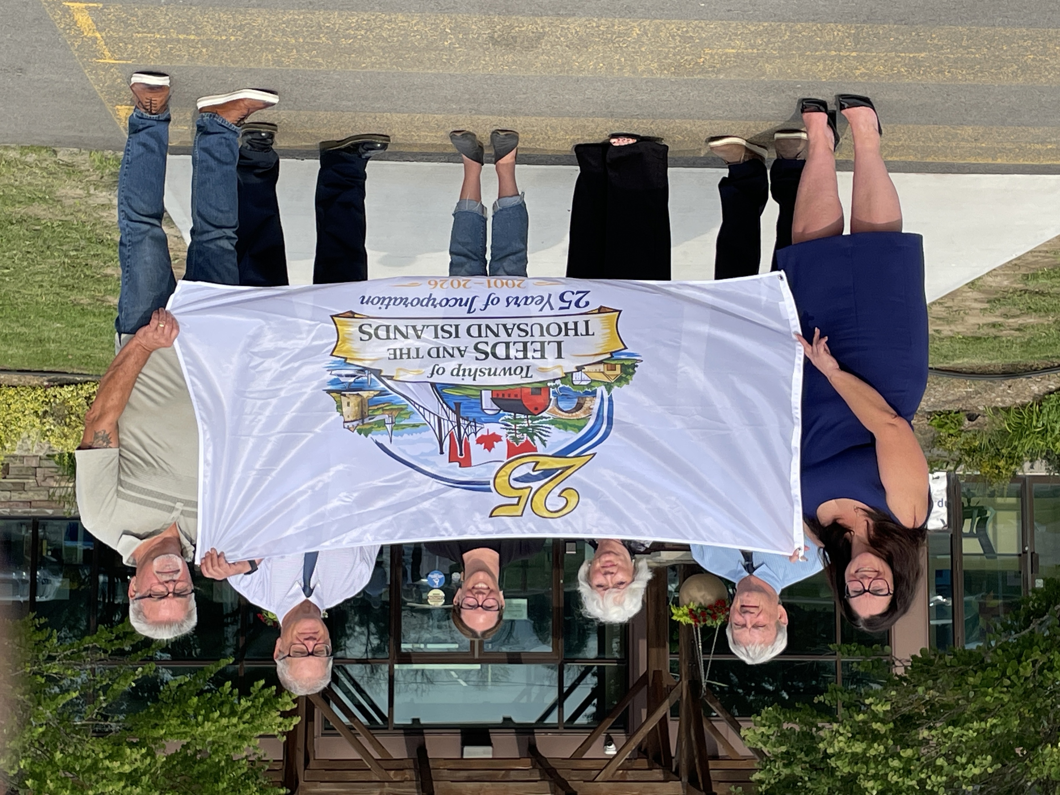 Group of people holding a commemorative flag