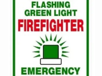Image of a green flashing light with the text Watch for flashing green light firefighter emergency response