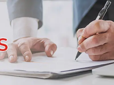 A picture of a hand signing a document with the word Tenders