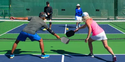 four pickleball players on a court