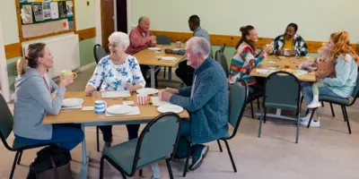Group of people sitting at round tables