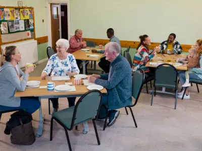 Group of people sitting at round tables