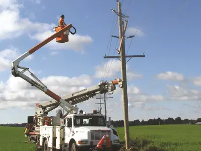 Hydro truck with worker in a bucket at a hydro pole