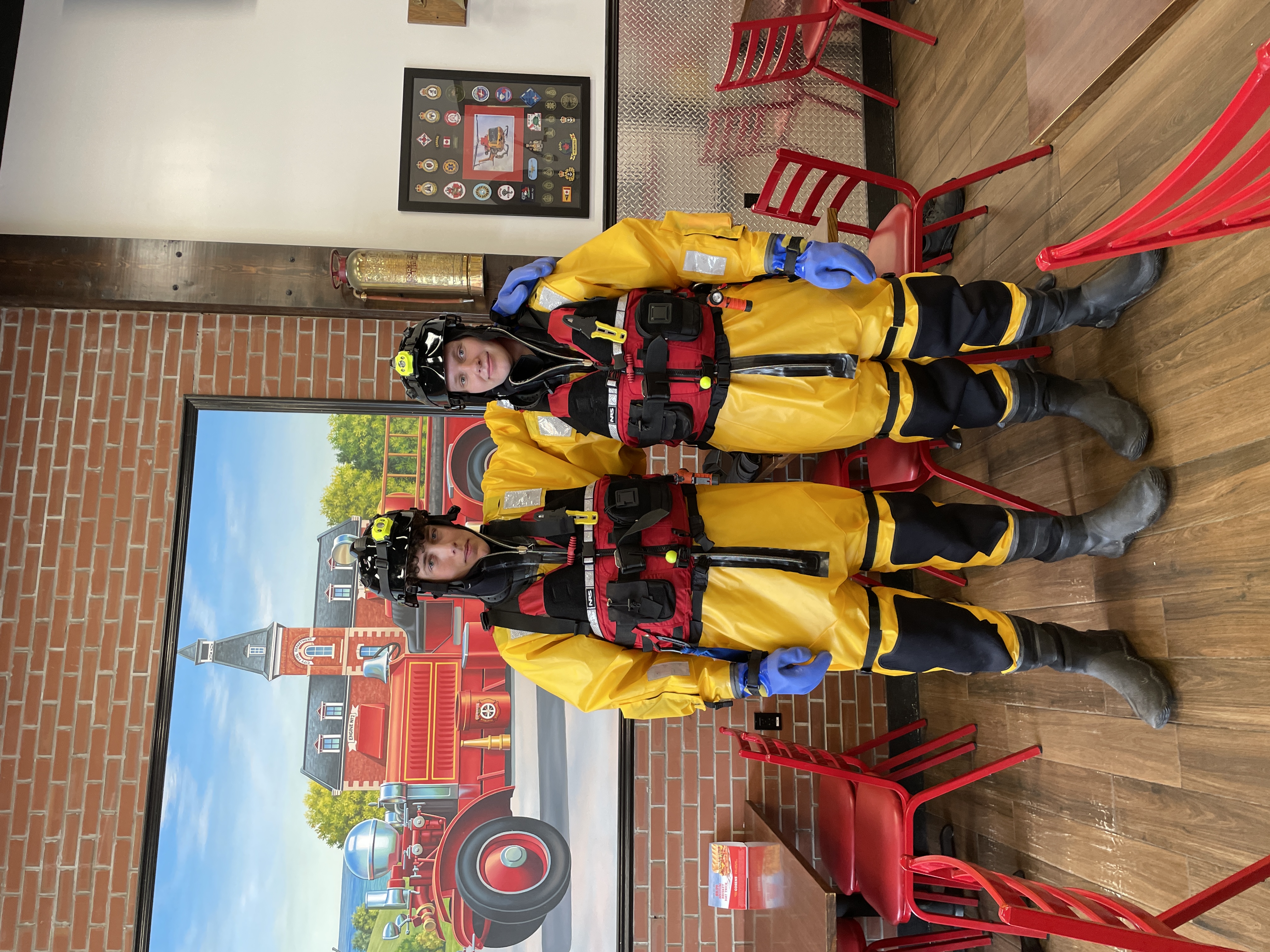 Two firefighters wearing Cold Weather Protective Equipment