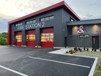 Fire station building with 3 red garage bay doors