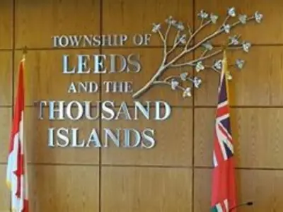 Council chambers with township logo and canadian and ontario flags