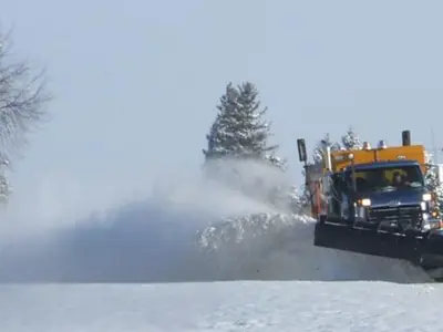 Snow plow truck clearing snow