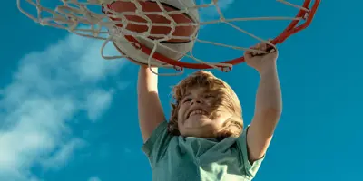 boy making a slam dunk